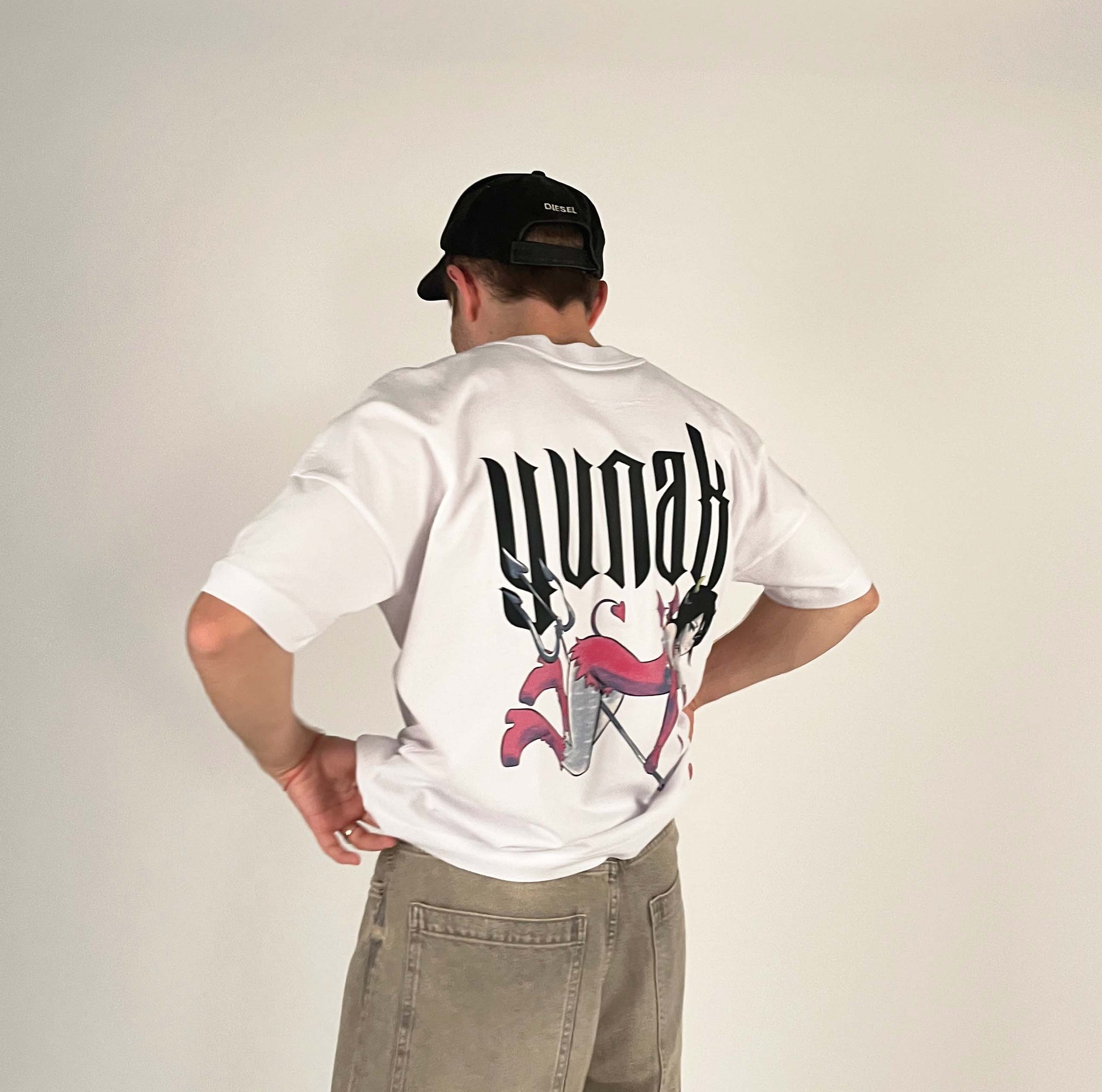 An oversized tshirt inspired by Rukia from Bleach. Anime Pump Cover for the gym with Yunak text and Rukia drawn as a demon from Bleach. Male model 3/4 design