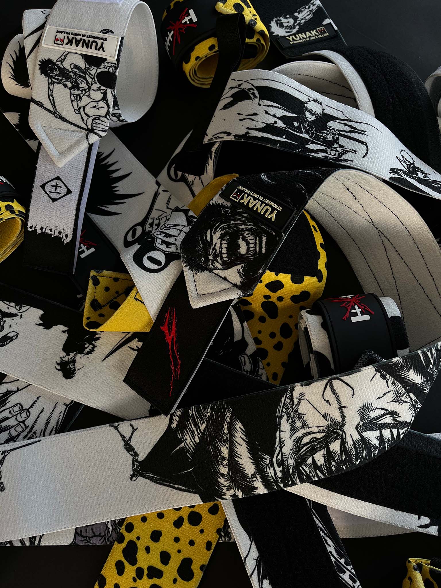 A mystery bundle containing one random pair of wrist wraps with anime inspired design. Picture shows a number of the anime wrist wraps that can be inside the package
