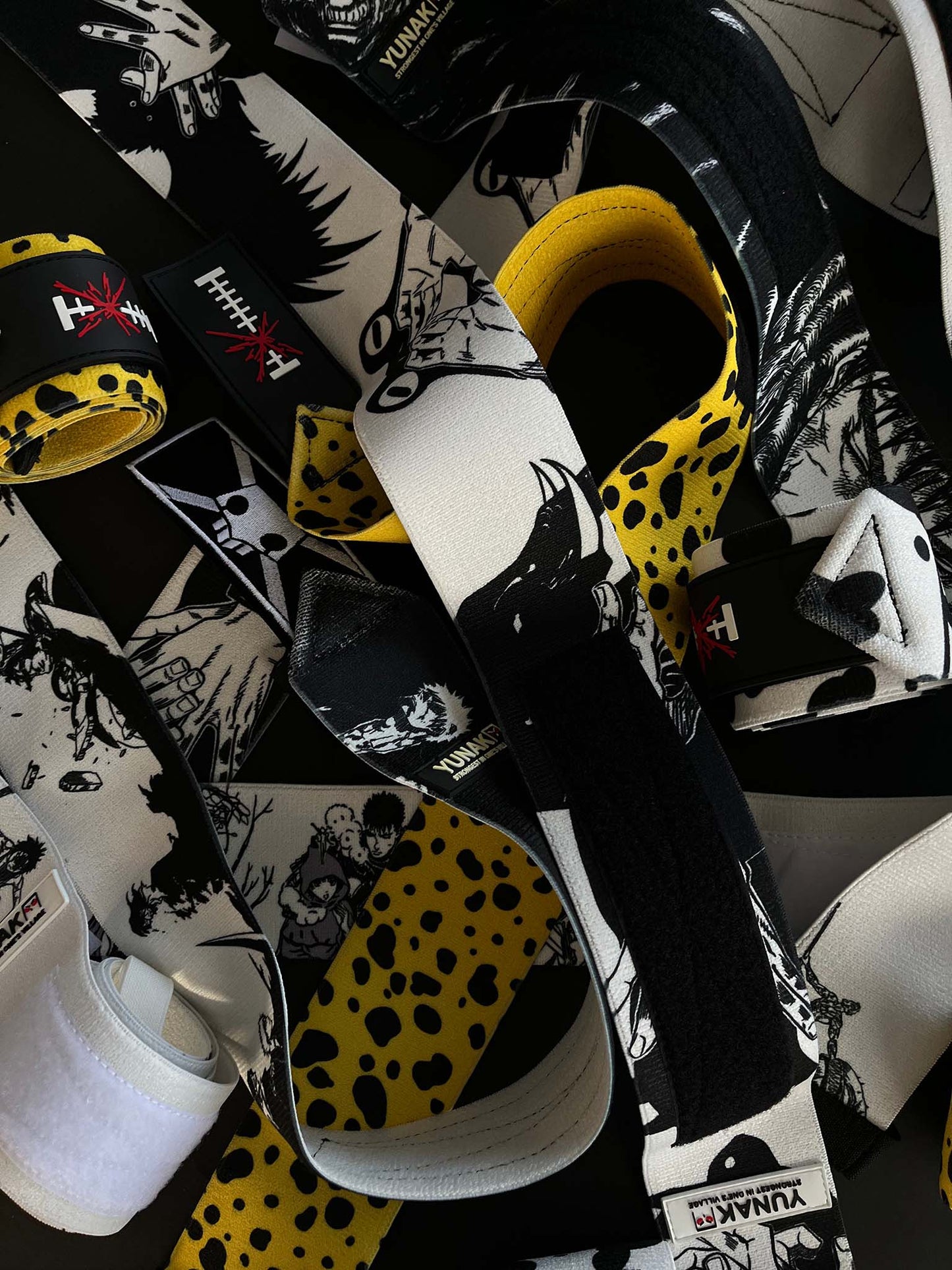 A mystery bundle containing one random pair of wrist wraps with anime inspired design. Picture shows a number of the anime wrist wraps that can be inside the package