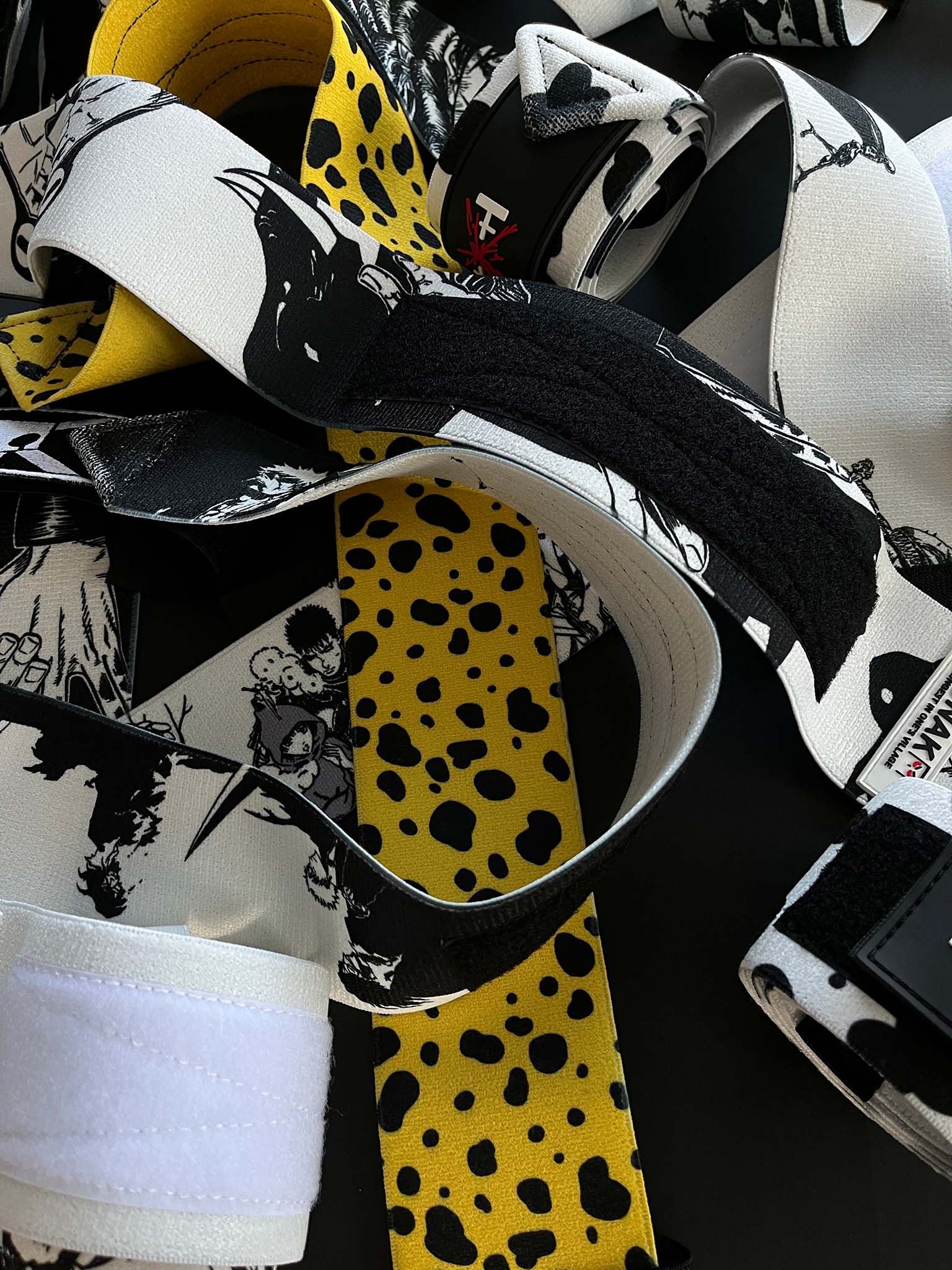 A mystery bundle containing one random pair of wrist wraps with anime inspired design. Picture shows a number of the anime wrist wraps that can be inside the package