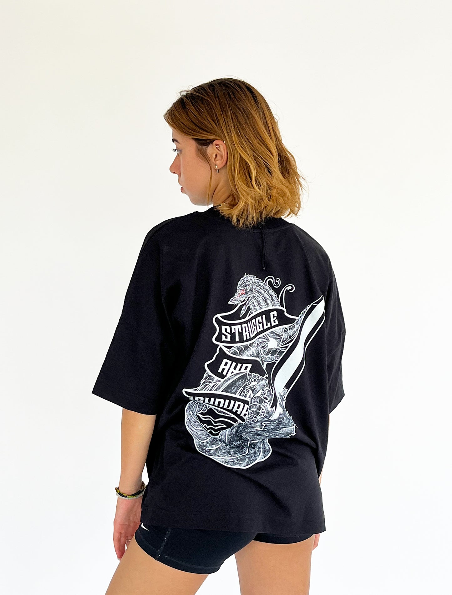 An oversized tshirt inspired by Guts from Berserk. Anime Pump Cover for the gym with Struggle and Endure text and Guts dog form from Berserk