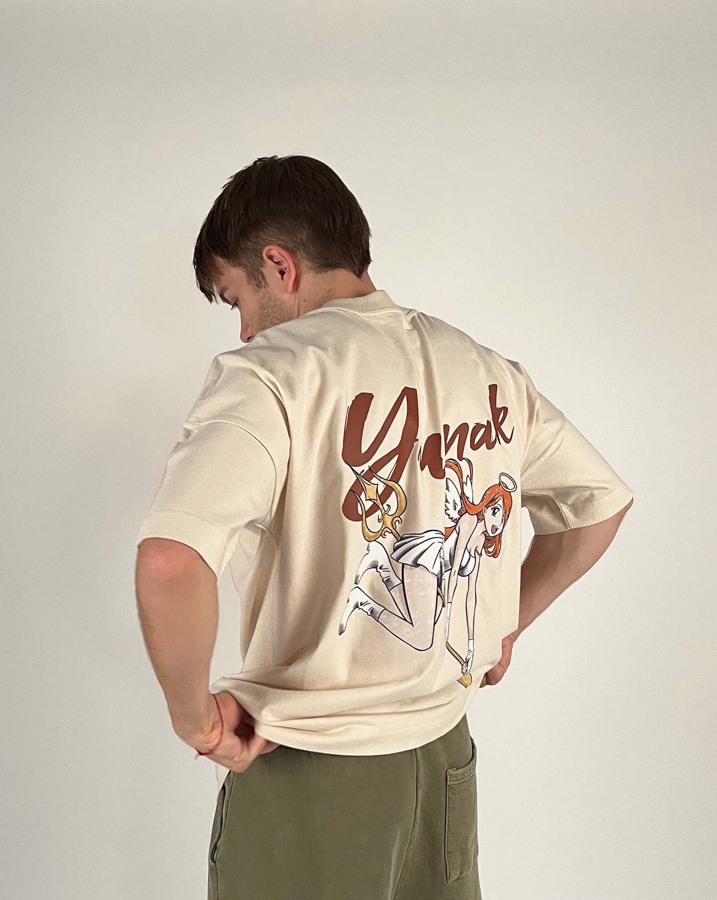 An oversized tshirt inspired by Orihime from Bleach. Anime Pump Cover for the gym with Yunak text and Orihime drawn as an angel from Bleach. Male model 3/4 design