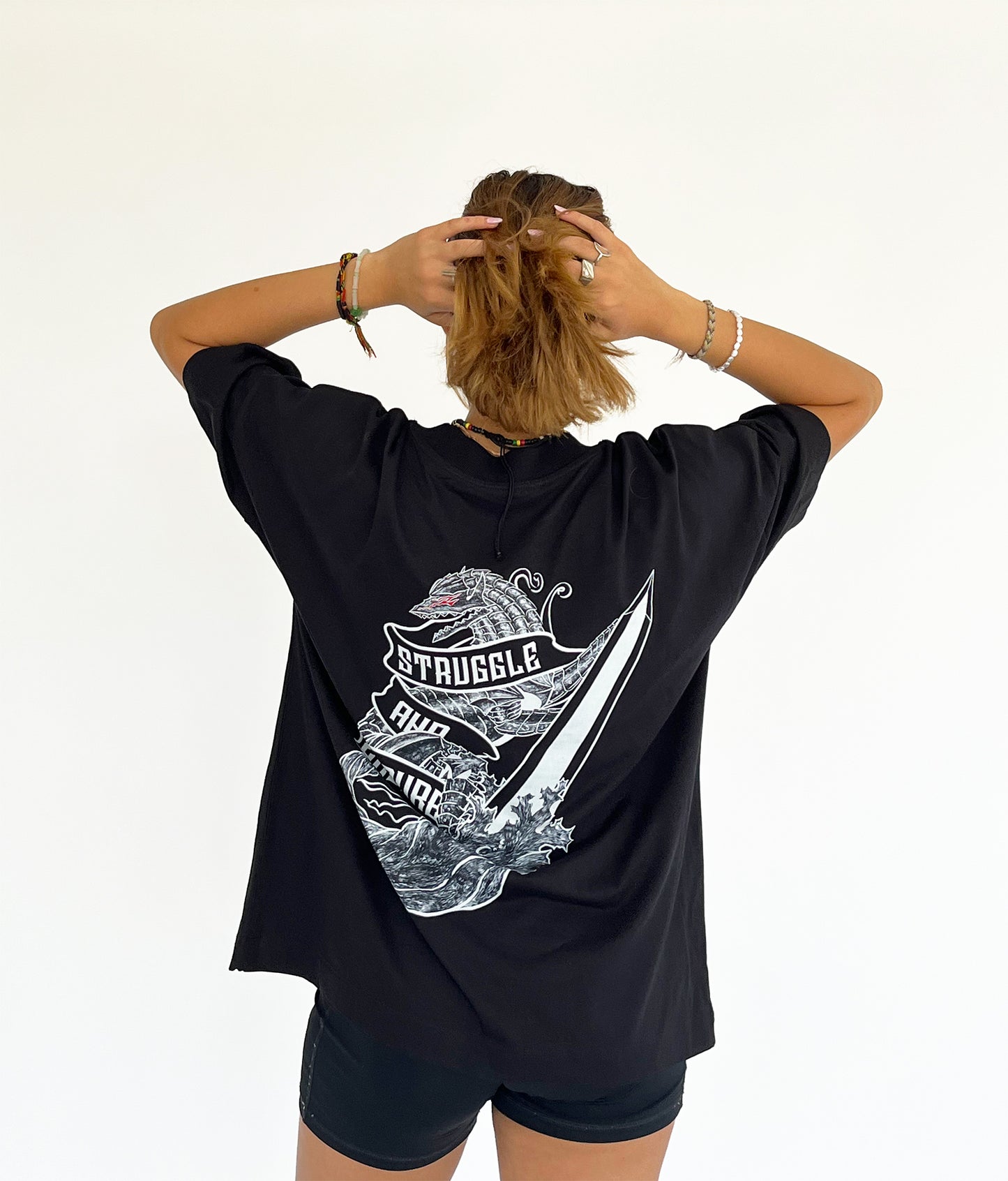 An oversized tshirt inspired by Guts from Berserk. Anime Pump Cover for the gym with Struggle and Endure text and Guts dog form from Berserk