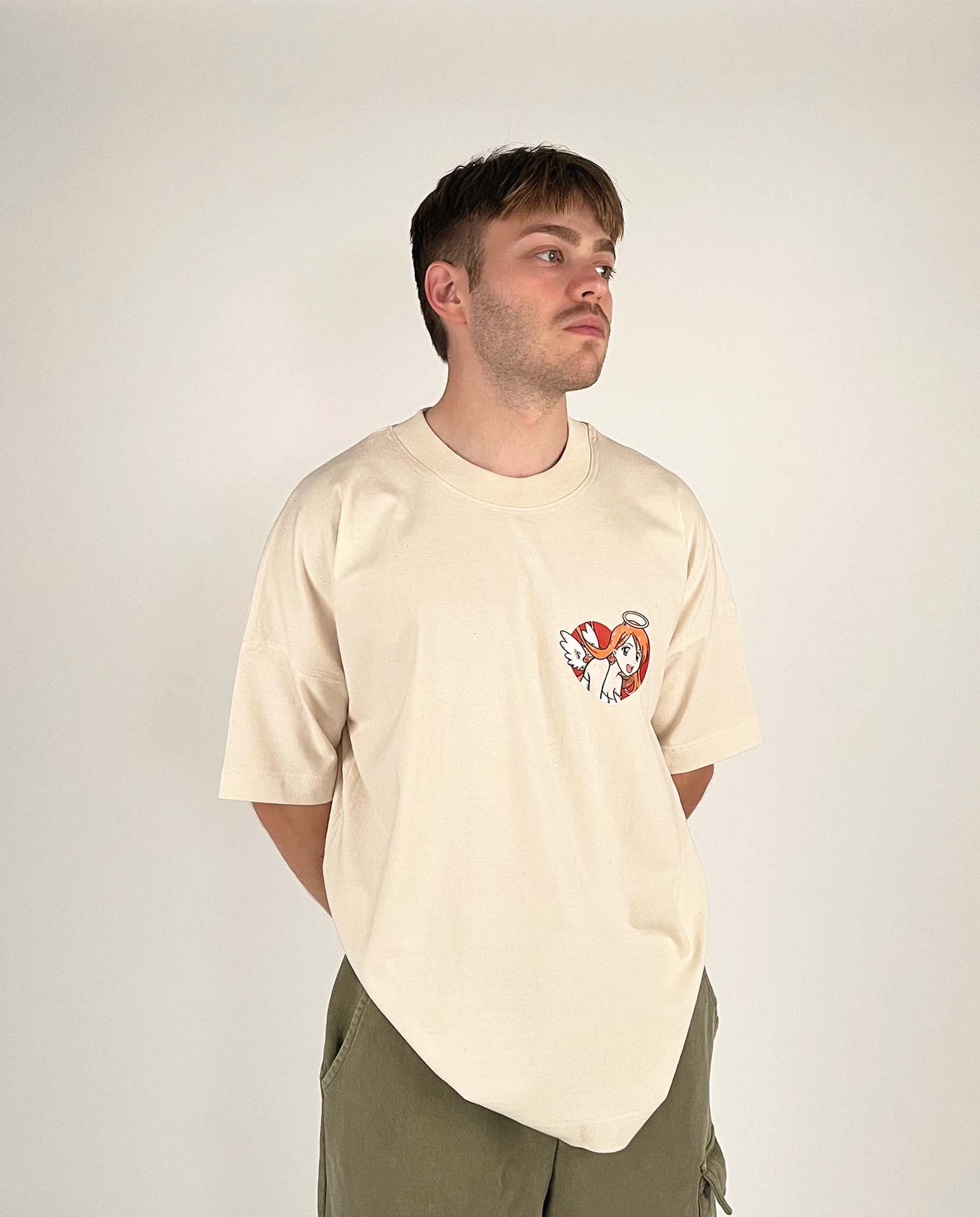 An oversized tshirt inspired by Orihime from Bleach. Anime Pump Cover for the gym with Yunak text and Orihime drawn as an angel from Bleach. Male model front design