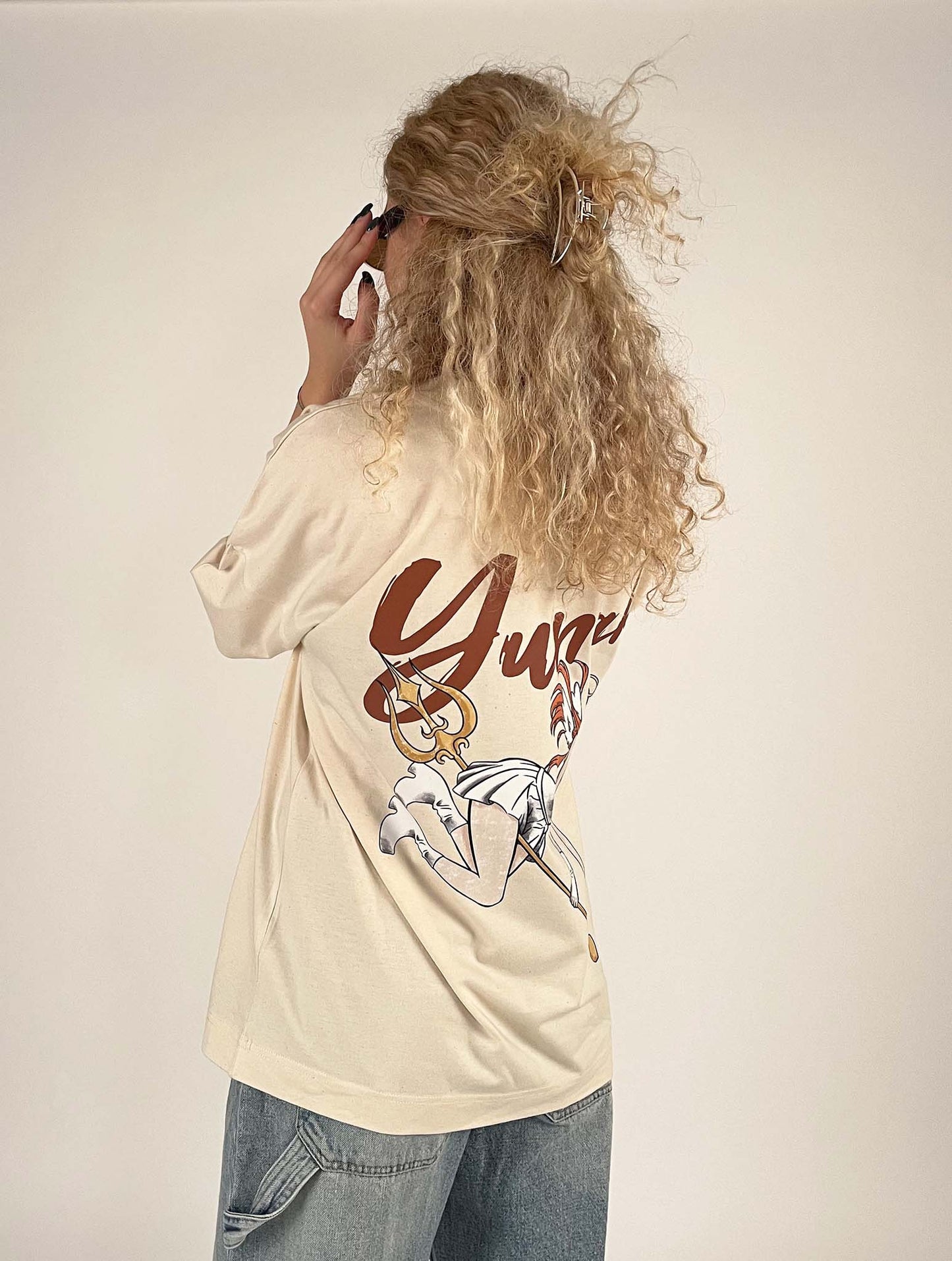 An oversized tshirt inspired by Orihime from Bleach. Anime Pump Cover for the gym with Yunak text and Orihime drawn as an angel from Bleach. Female model 3/4 design