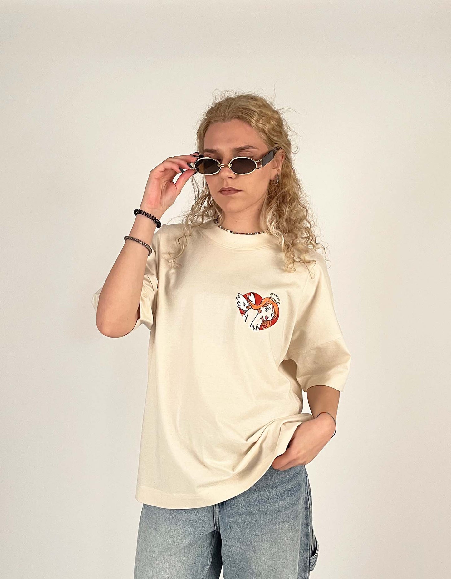 An oversized tshirt inspired by Orihime from Bleach. Anime Pump Cover for the gym with Yunak text and Orihime drawn as an angel from Bleach. Female model front design