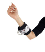A pair of cable cuffs inspired by Kuromi from Hello Kitty Sanrio on a female model