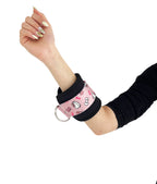 A pair of cable cuffs inspired by Hello Kitty from Sanrio. Detail shot on a female model