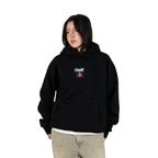 Person wearing a black hoodie with Yunak x HunterxHunter graphic on the front, standing against a white background