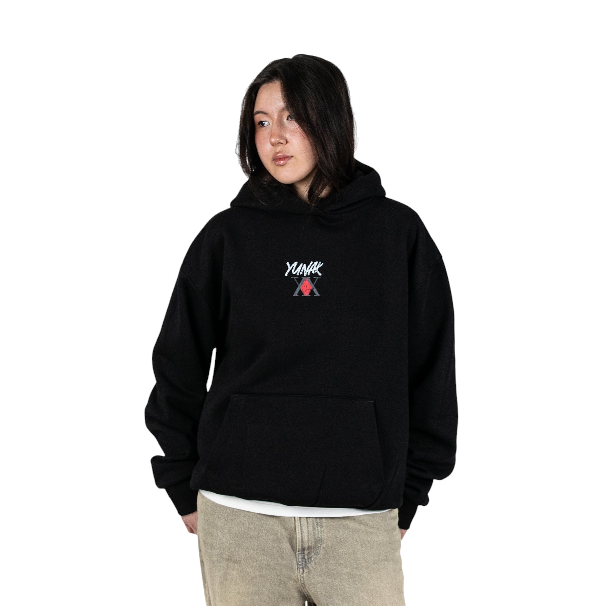 Person wearing a black hoodie with Yunak x HunterxHunter graphic on the front, standing against a white background