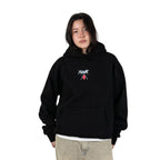 Person wearing a black hoodie with Yunak x HunterxHunter graphic on the front, standing against a white background