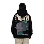 Person wearing a black hoodie with graphic design of Gon from HunterxHunter on the back, standing against a white background