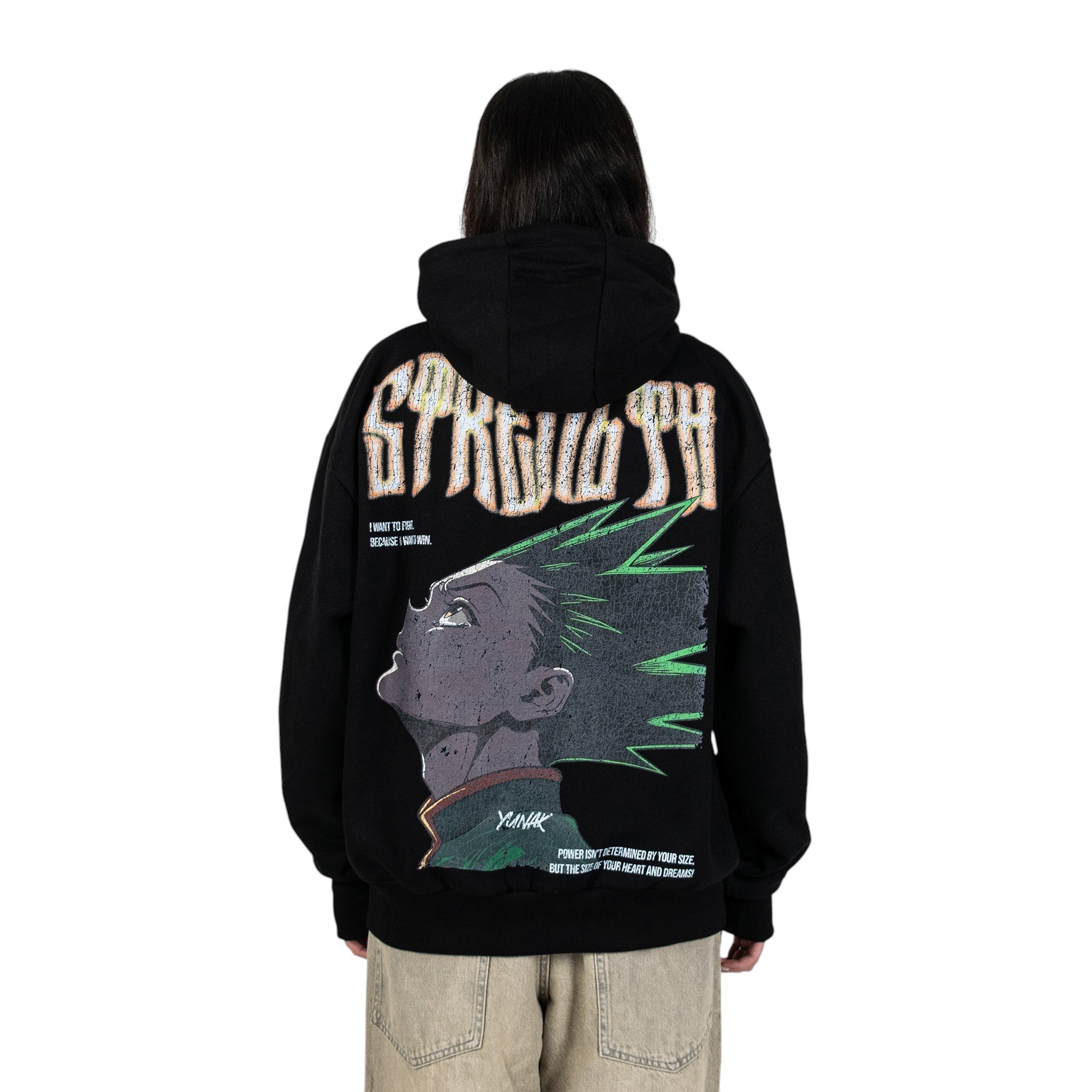 Person wearing a black hoodie with graphic design of Gon from HunterxHunter on the back, standing against a white background