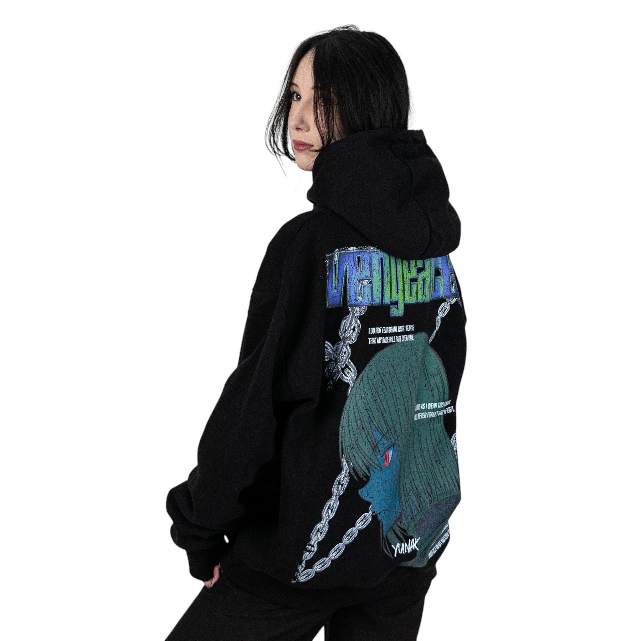 Person wearing a black hoodie with graphic design of Kurapika from HunterxHunter on the back, standing against a white background