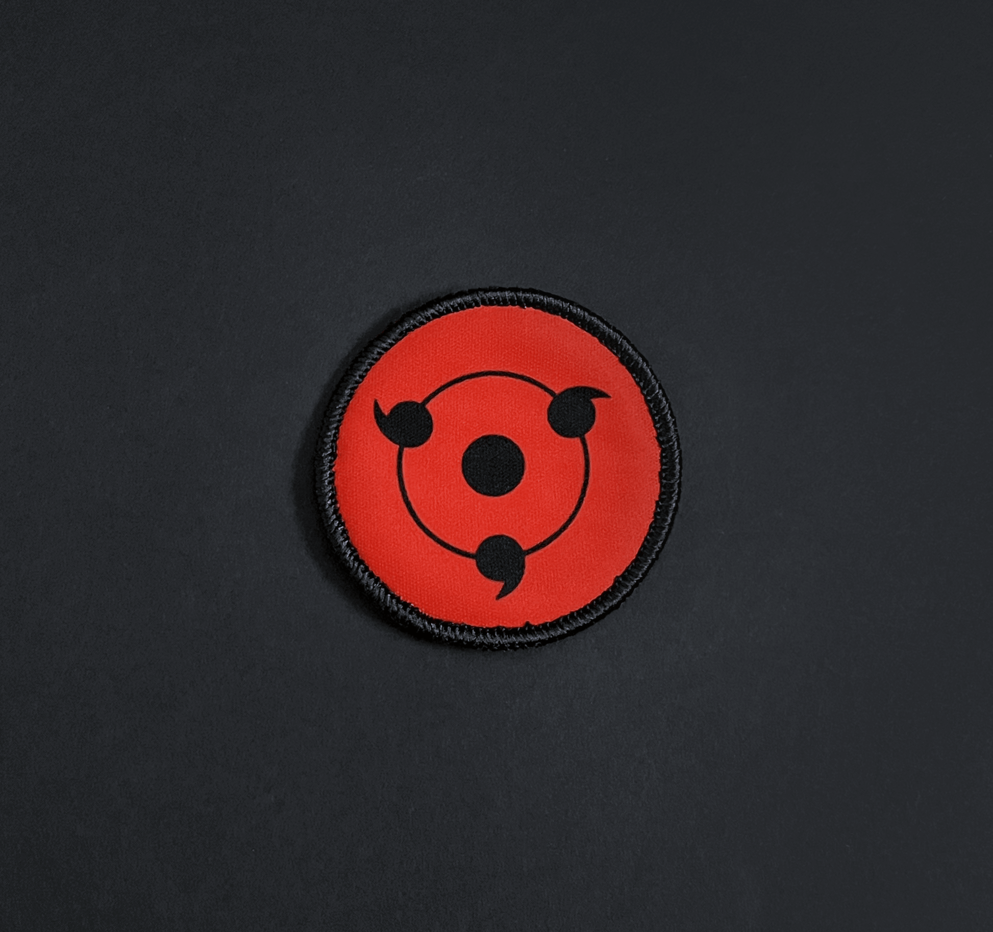 A top down view of the Sharingan embroidery patch.