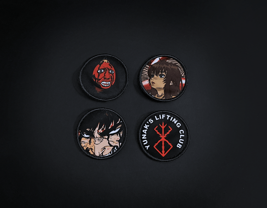 A photo of the 4 anime embroidery patches that come with this belt variation. First patch is behelit. Second patch is Casca, third is featuring Guts and the fourth is a Yunak's Lifting Club patch. The photo is top down view of the patches.