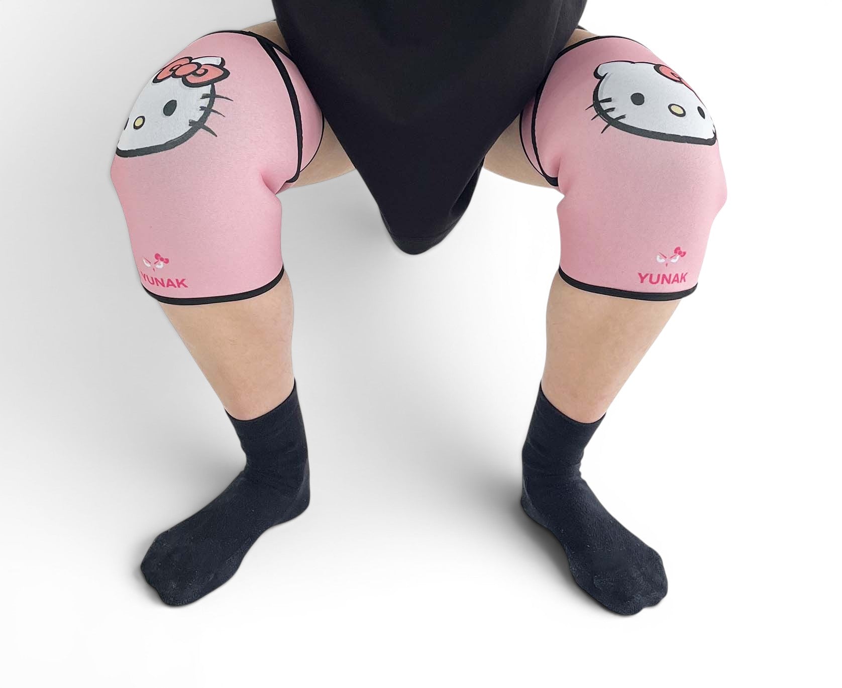 7mm thick knee sleeves inspired by Hello Kitty from Sanrio. Anime knee sleeves for the gym with Hello Kitty anime design for weightlifting. Detail shot in squatting position