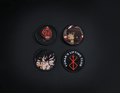 A photo of the 4 anime embroidery patches that come with this belt variation. First patch is behelit. Second patch is Casca, third is featuring Guts and the fourth is a Yunak's Lifting Club patch. The photo is top down view of the patches.