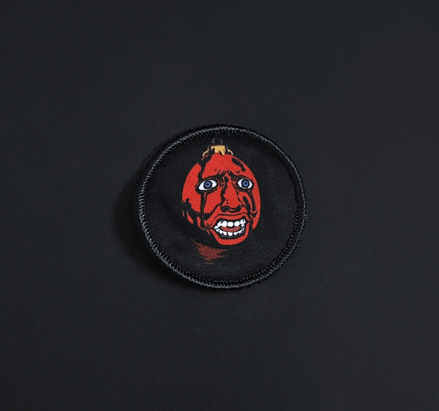 A top down view of the behelit embroidery patch
