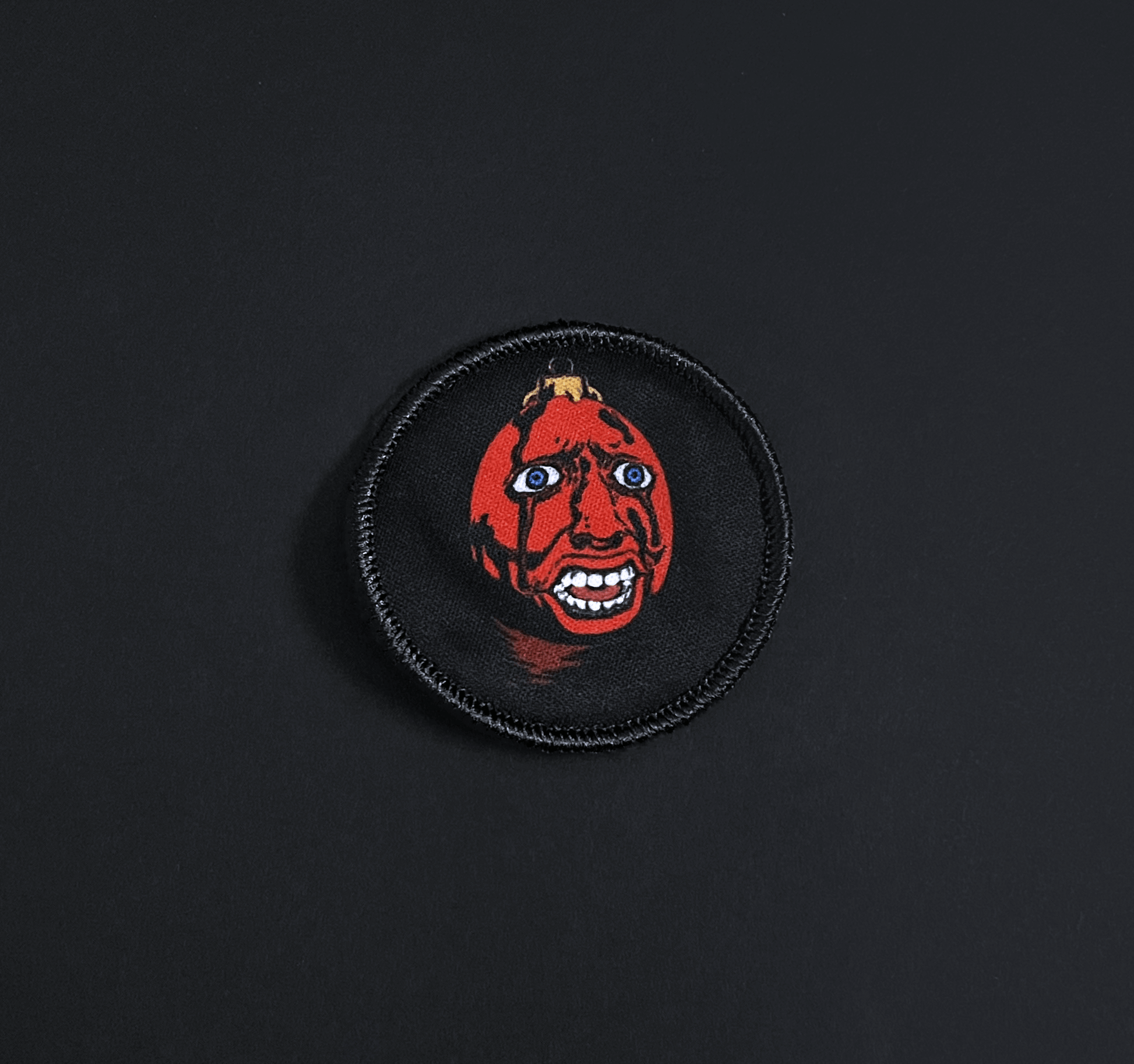 A top down view of the behelit embroidery patch