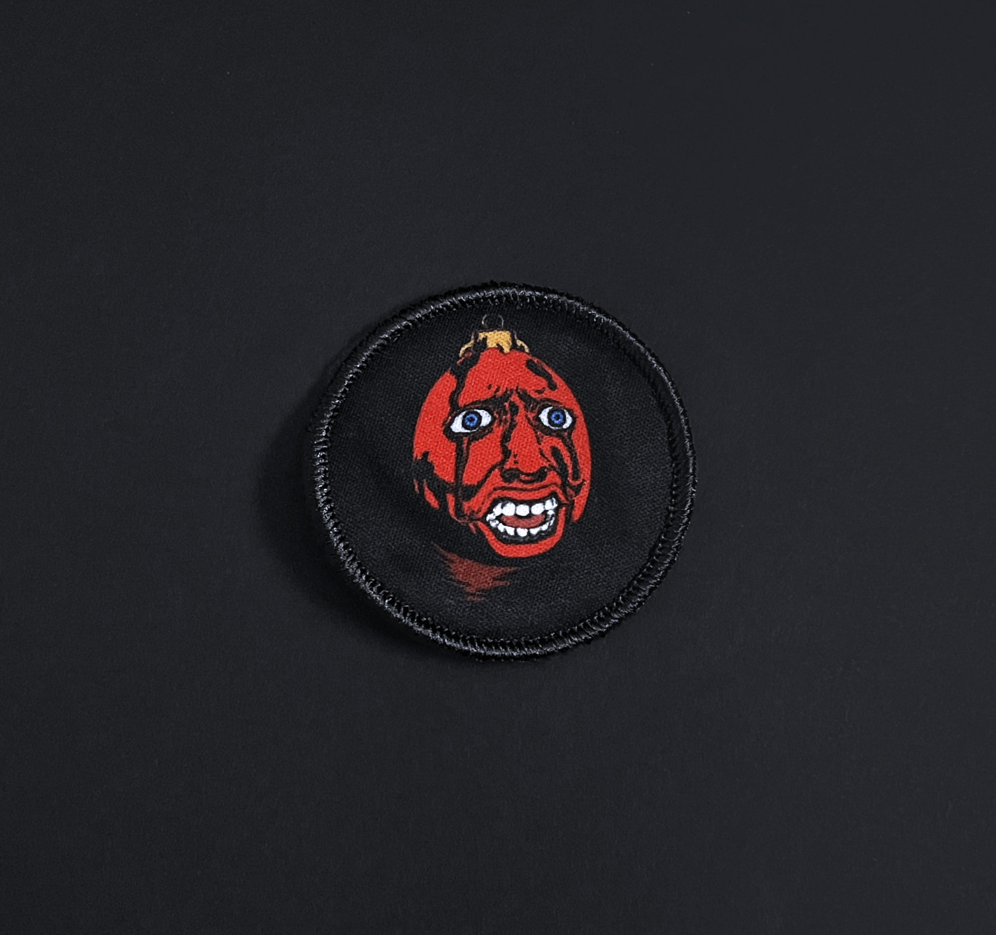A top down view of the behelit embroidery patch