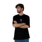 Person wearing a black t-shirt with Yunak x HunterxHunter graphic on the front, standing against a white background