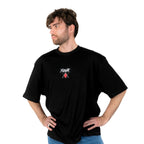 Person wearing a black t-shirt with Yunak x HunterxHunter graphic on the front, standing against a white background