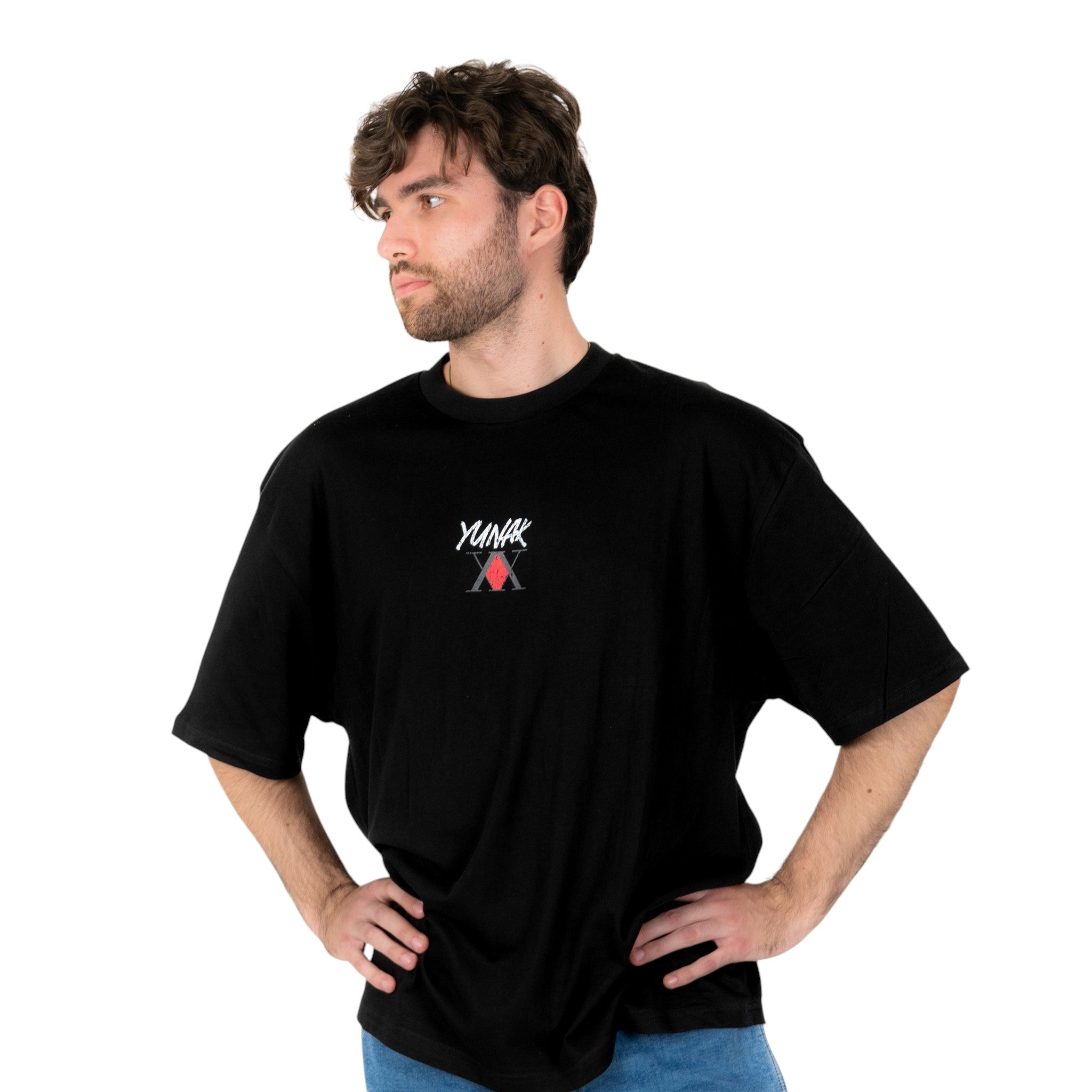 Person wearing a black t-shirt with Yunak x HunterxHunter graphic on the front, standing against a white background
