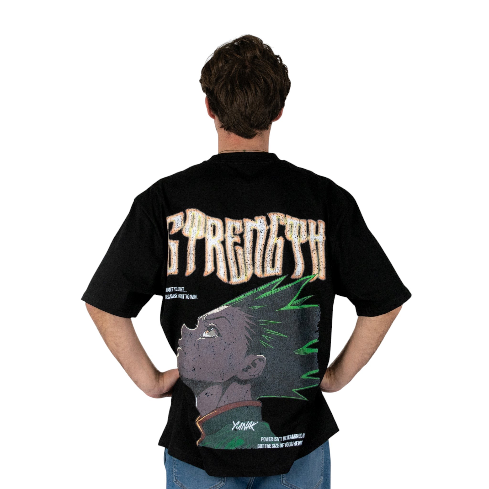 Person wearing a black t-shirt with graphic design of Gon from HunterxHunter on the back, standing against a white background