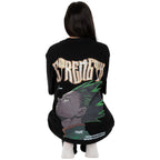 Person wearing a black t-shirt with graphic design of Gon from HunterxHunter on the back, squatting against a white background
