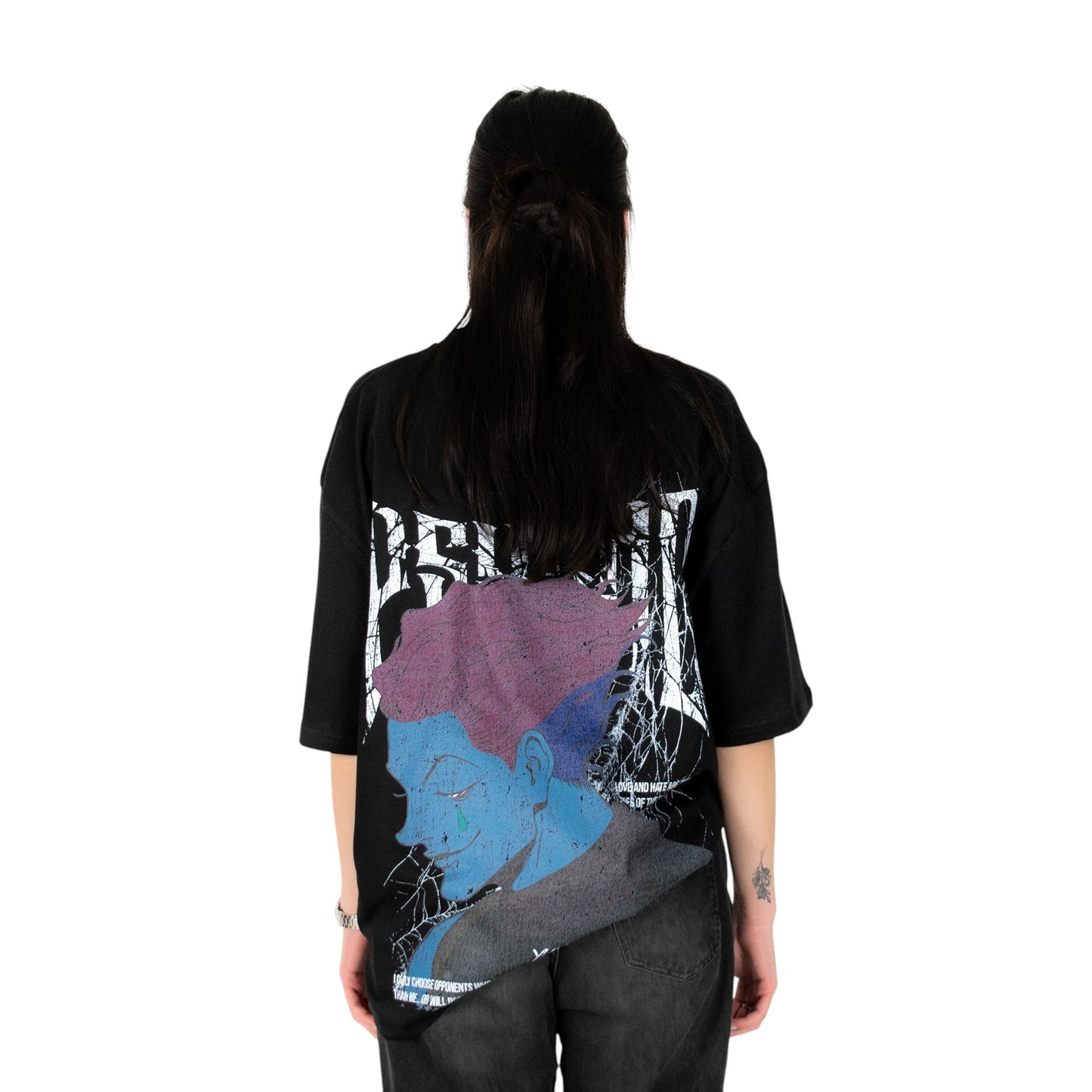 Person wearing a black t-shirt with graphic design of Hisoka from HunterxHunter on the back, standing against a white background