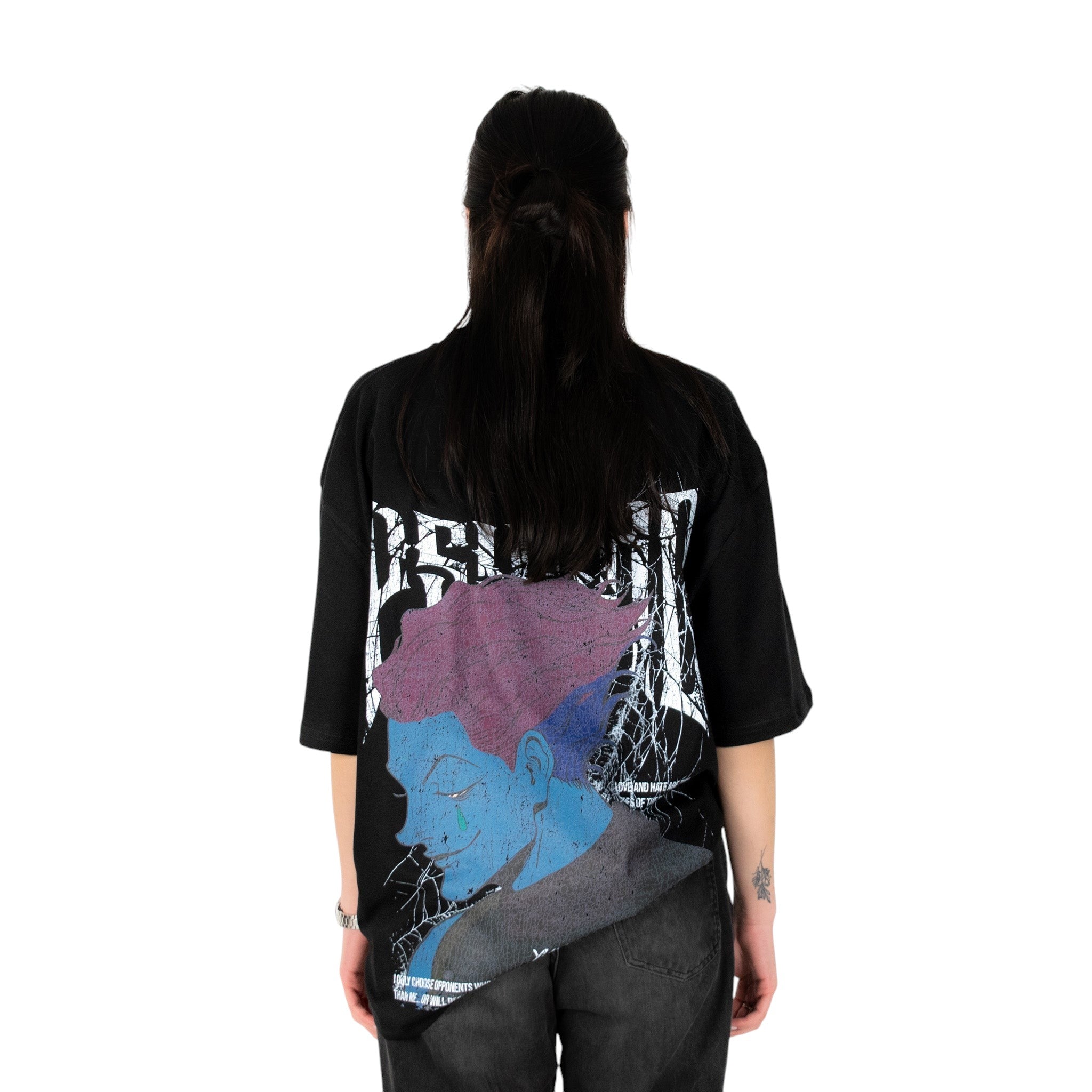 Person wearing a black t-shirt with graphic design of Hisoka from HunterxHunter on the back, standing against a white background