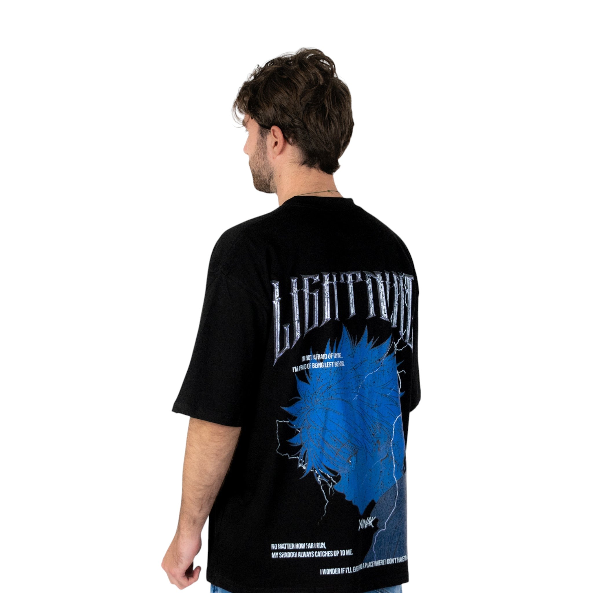 Person wearing a black t-shirt with graphic design of Killua from HunterxHunter on the back, standing against a white background