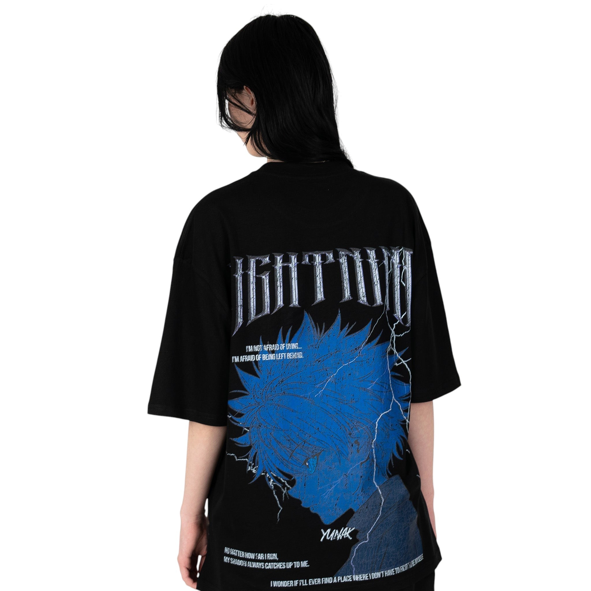 Person wearing a black t-shirt with graphic design of Killua from HunterxHunter on the back, standing against a white background