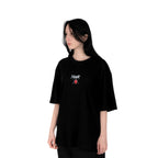 Person wearing a black t-shirt with Yunak x HunterxHunter graphic on the front, standing against a white background