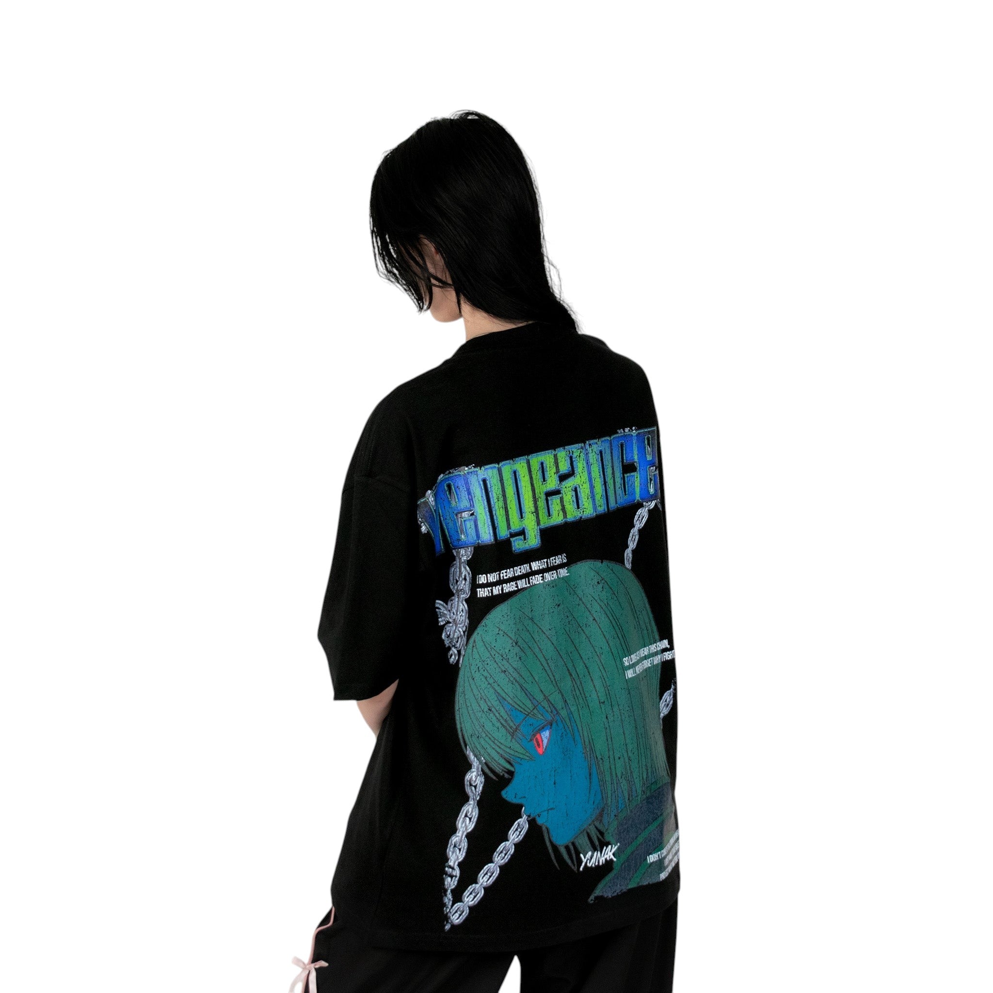 Person wearing a black t-shirt with graphic design of Kurapika from HunterxHunter on the back, standing against a white background