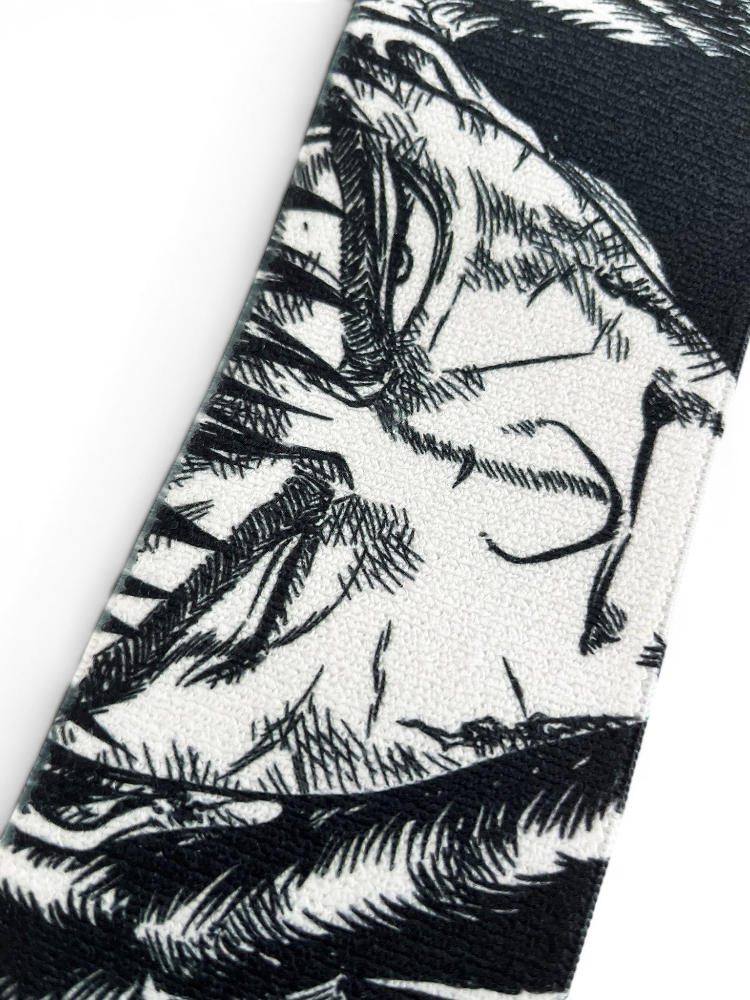 Embroidered anime wrist wraps inspired by Guts and Casca from Berserk. Anime lifting wraps for the gym. Close detail shot