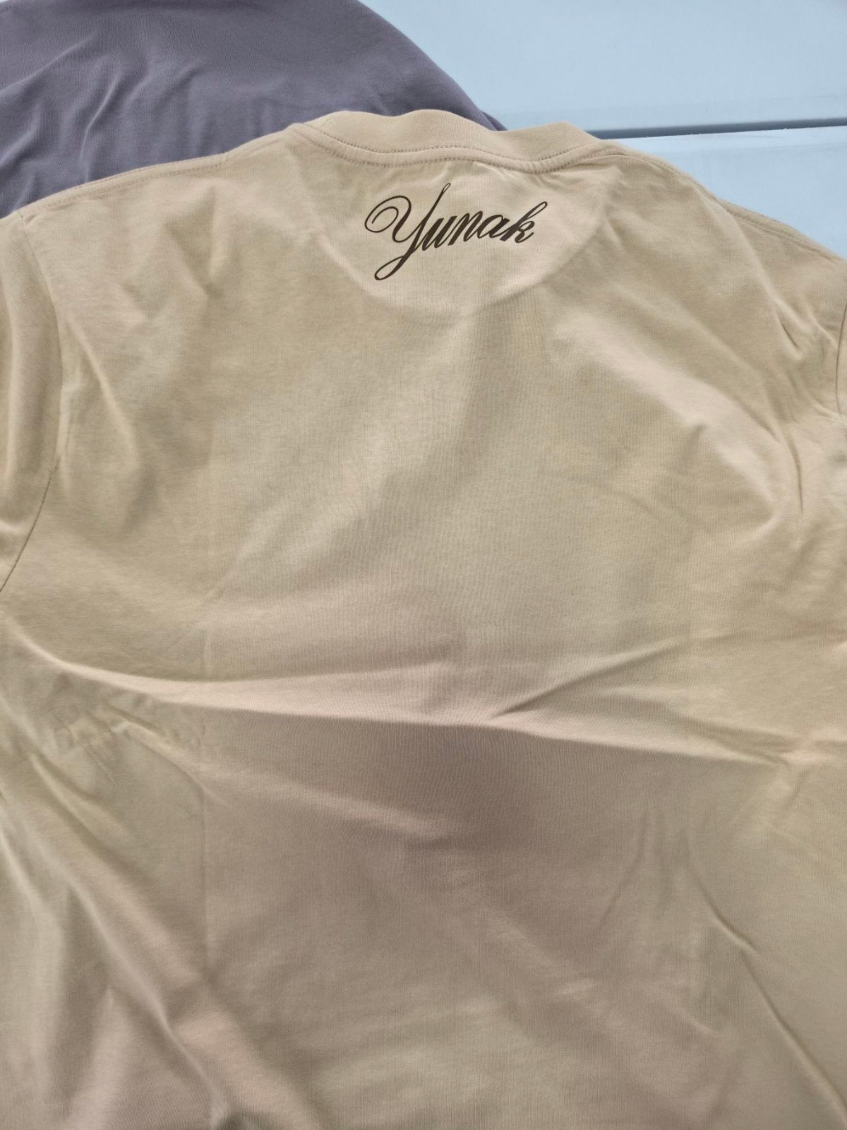 Person wearing a black t-shirt with graphic design of Ryu from Jujutsu Kaisen on the back, standing against a white background