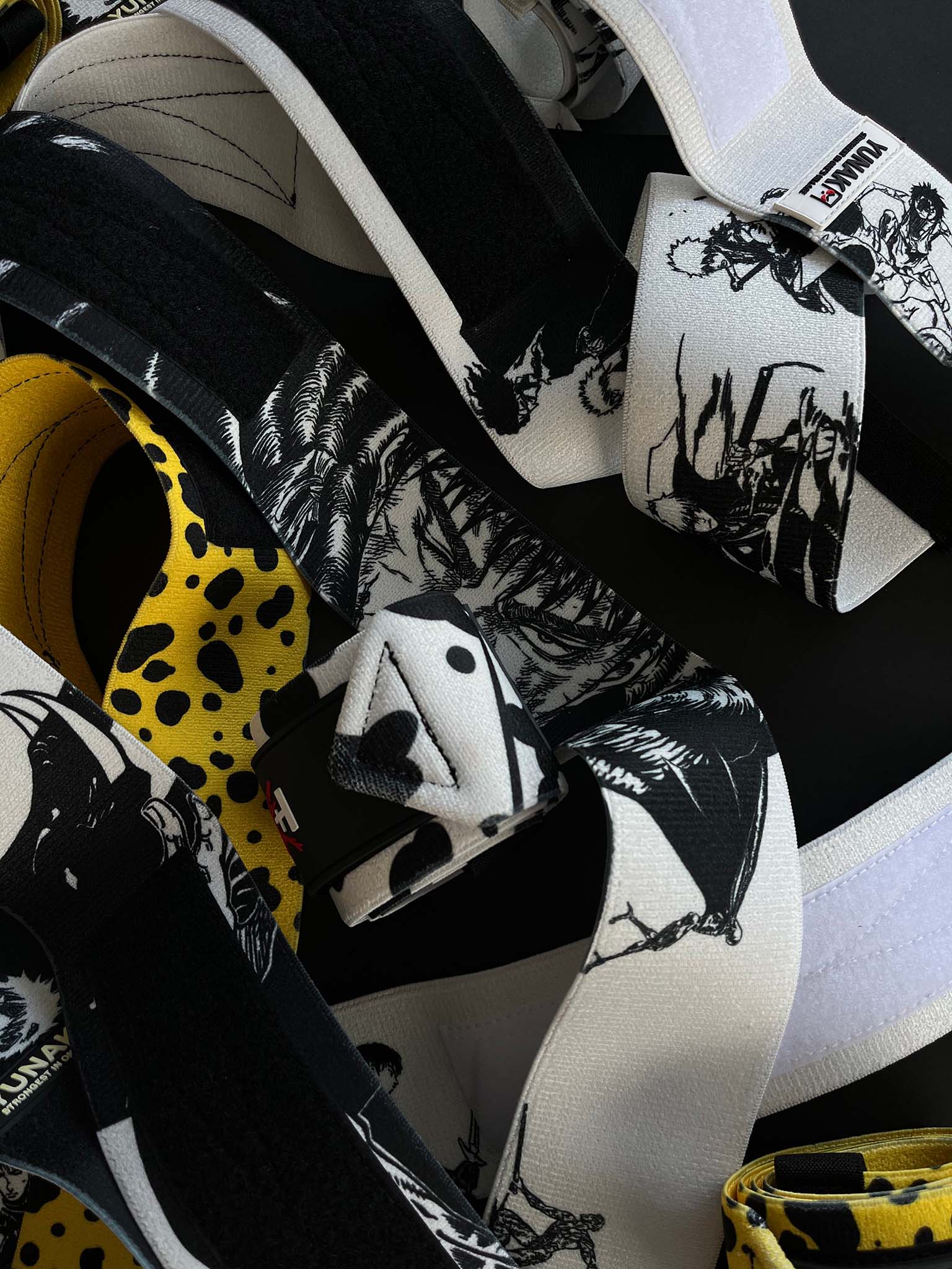 A mystery bundle containing one random pair of wrist wraps with anime inspired design. Picture shows a number of the anime wrist wraps that can be inside the package