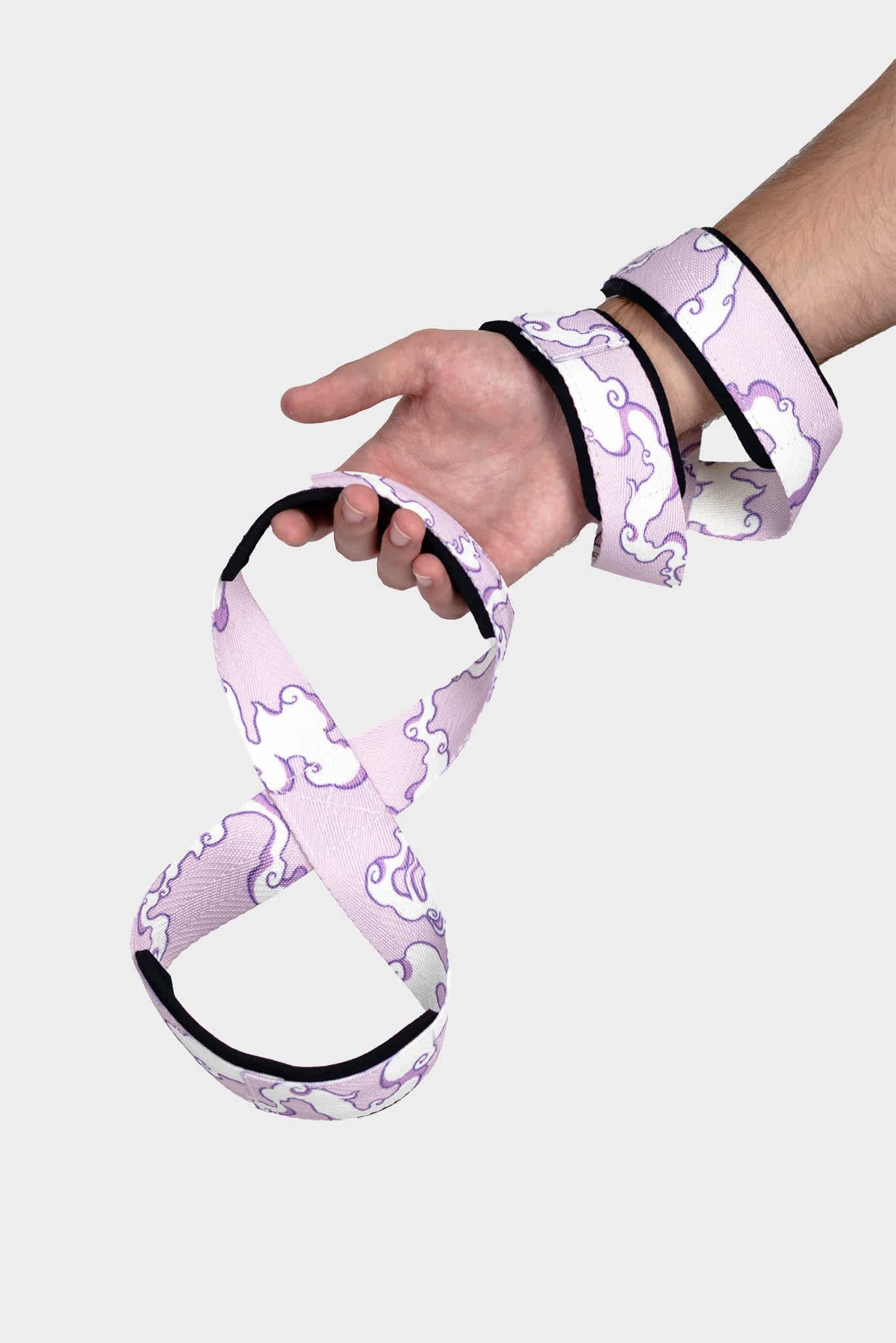 A hand holding an 8 figure lifting strap with a Luffy Gear 5 pattern.